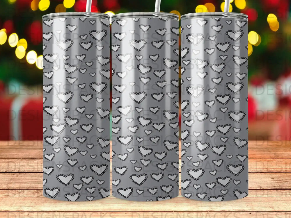 Silver tumbler with repeating white scalloped heart pattern.