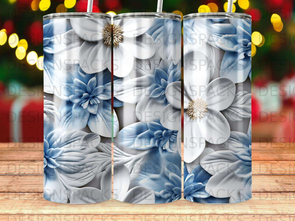 Three tumblers with a repeating pattern of white and blue 3D flowers.
