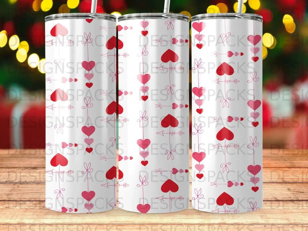 Three tumblers with a repeating pattern of pink hearts and bows.