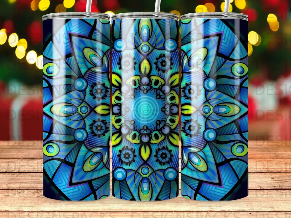Blue and green mandala design on a tumbler with bokeh lights background.