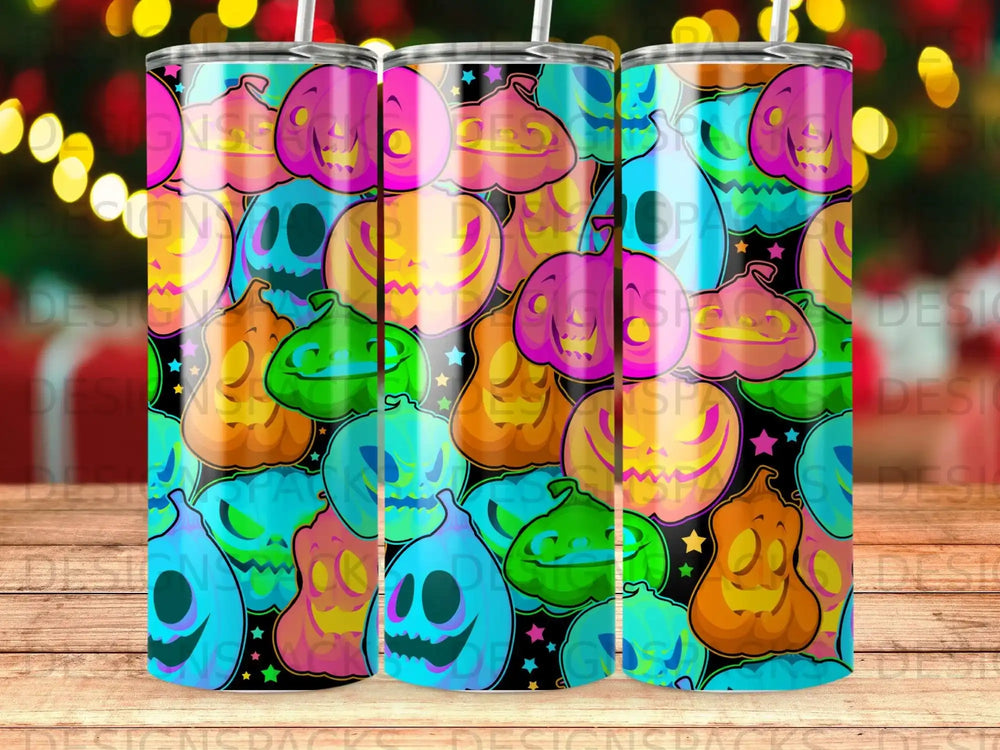 Halloween jack-o'-lanterns on a patterned tumbler, with bokeh lights in background.