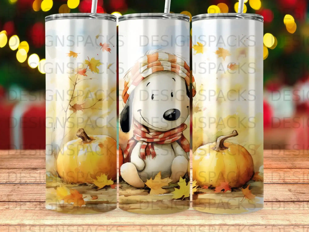Snoopy wearing a scarf and hat sits with pumpkins and autumn leaves.