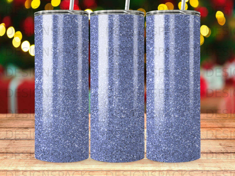 Three glittering blue tumblers with straws in a studio setting.