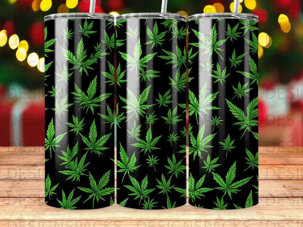 Black tumbler with repeating green cannabis leaf pattern and straw.