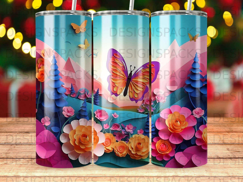 Floral and butterfly pattern on three tumblers with mountain and tree background.