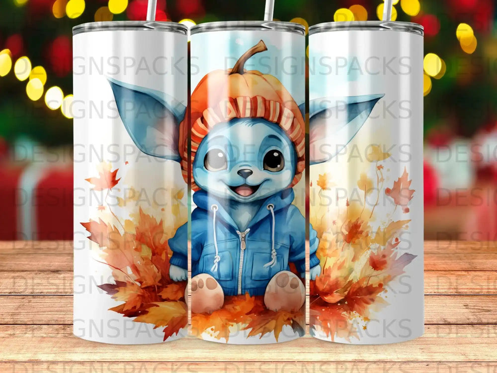 Blue creature in orange hat and blue hoodie sits among autumn leaves.