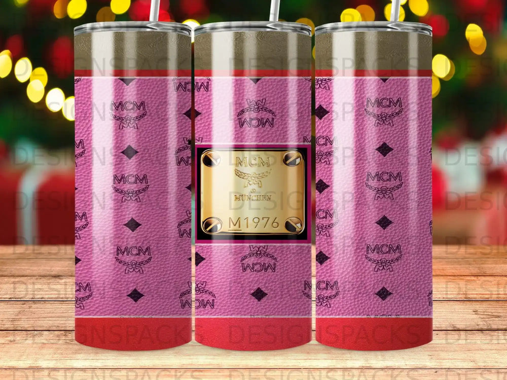 MCM logo pattern on a pink tumbler with gold emblem and "MCM Munich 1976".