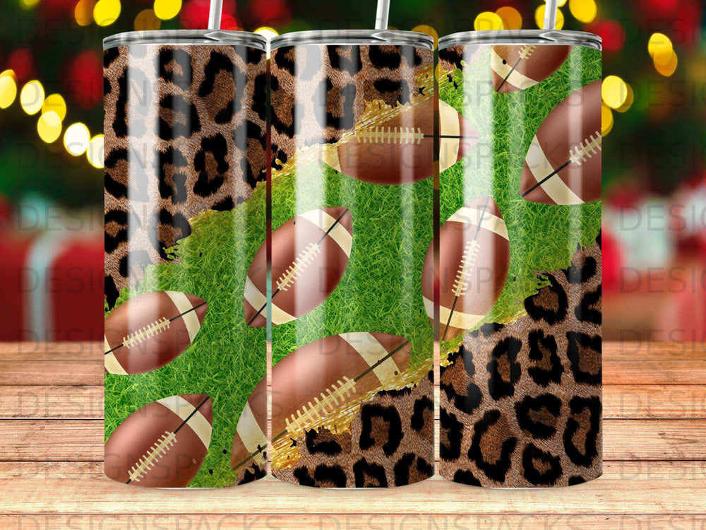 Three tumblers with leopard print and football designs on a grass background.