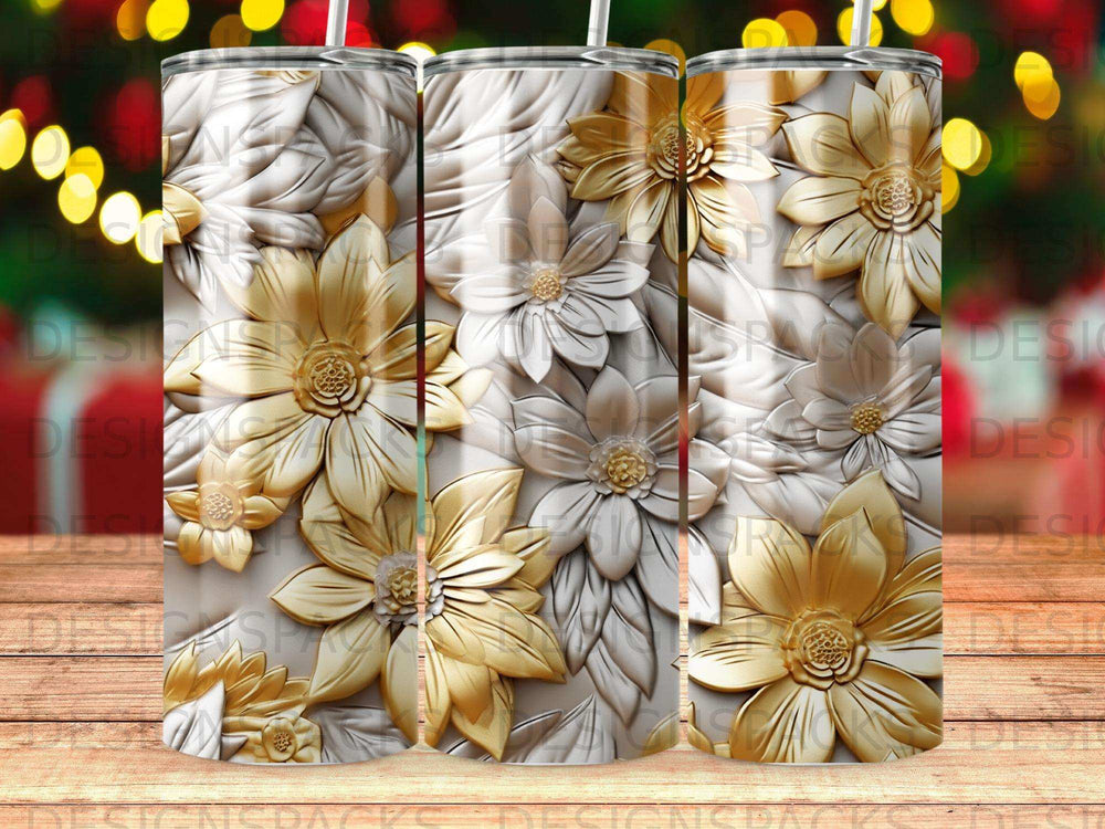 Three tumblers with embossed gold and silver floral patterns.