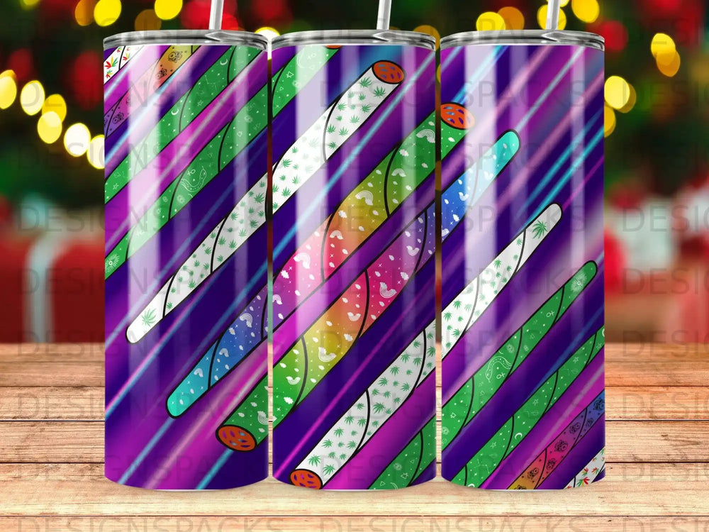 Three tumblers with diagonal stripes and colorful holiday patterns.
