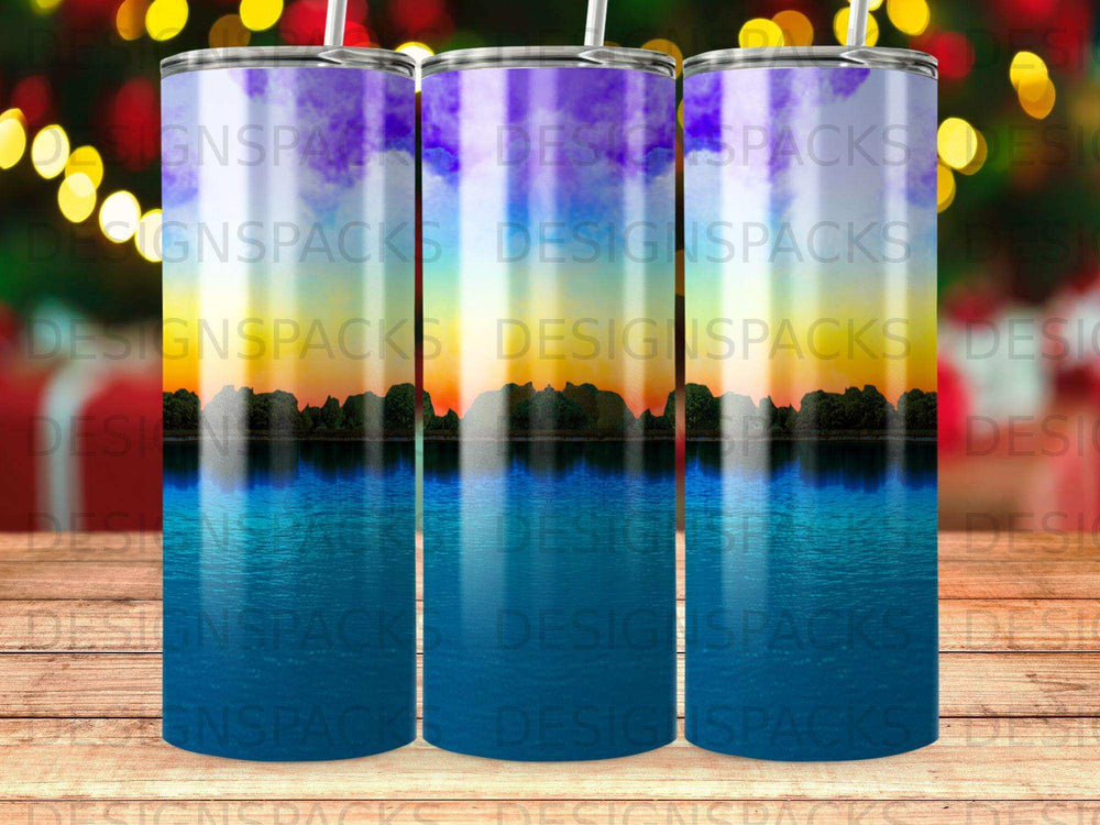 Three tumblers with a sunset over water design.