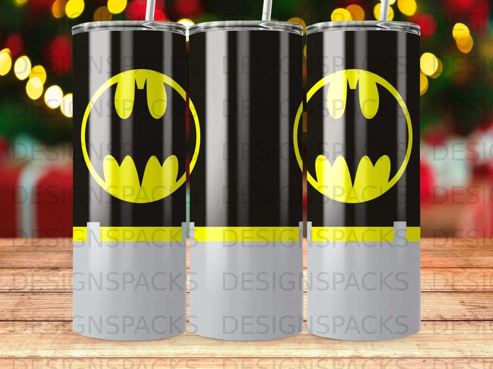 Three Batman logo tumblers with straw, lined up against a bokeh background.