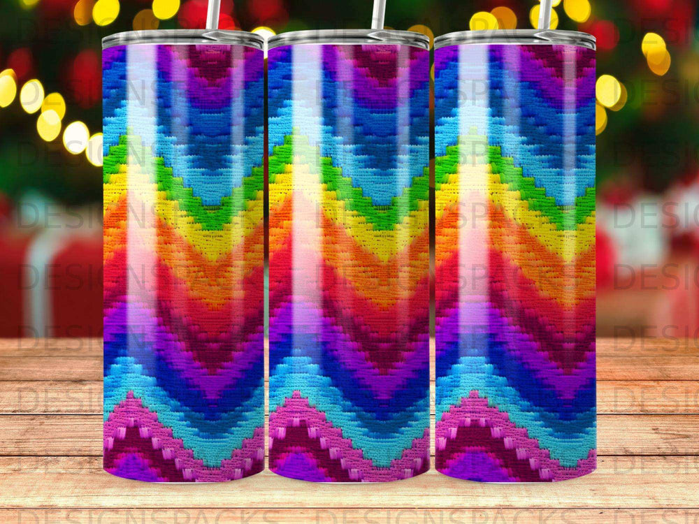 Three identical tumblers with a colorful, striped, chevron-like pattern.
