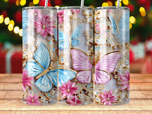 Three tumblers with blue and pink butterflies, flowers, and gems.