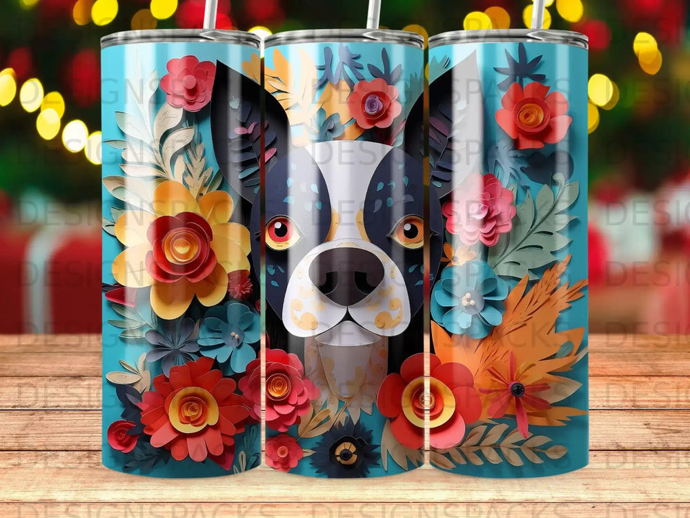 Dog face surrounded by colorful paper flowers on a blue tumbler.