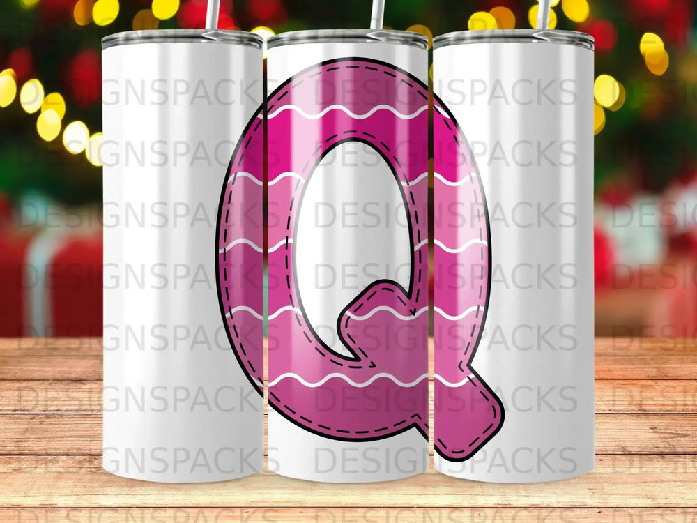 Tumbler with pink letter Q design and "DESIGNSPACKS" repeating watermark.