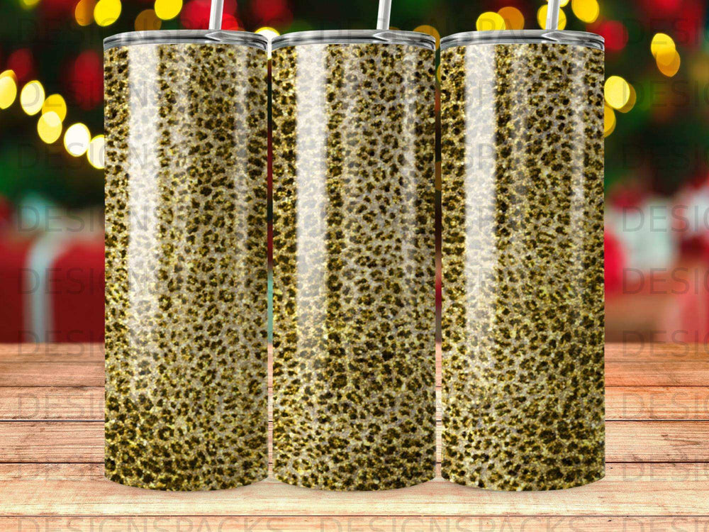 Three tumblers with a gold leopard print pattern, standing upright.