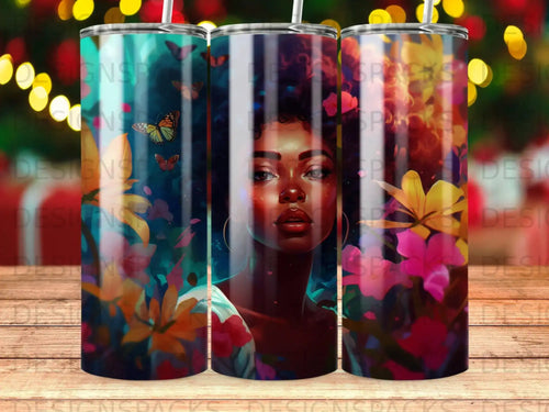 Tumbler with portrait of a woman with butterflies and flowers.