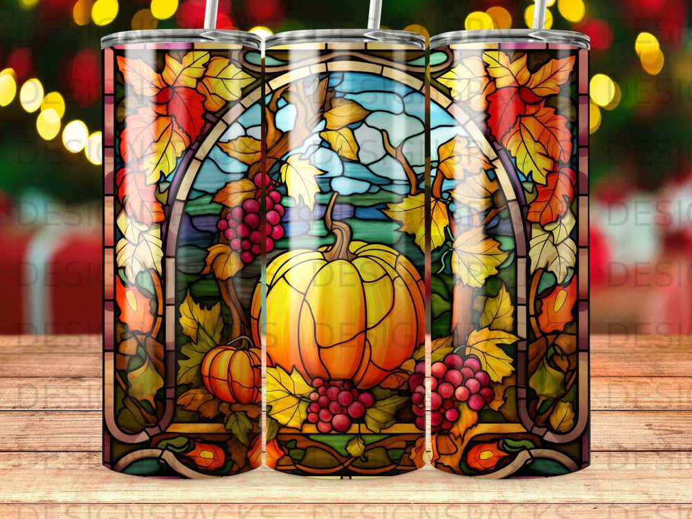 Stained glass tumbler with pumpkin, grapes, and autumn leaves design.