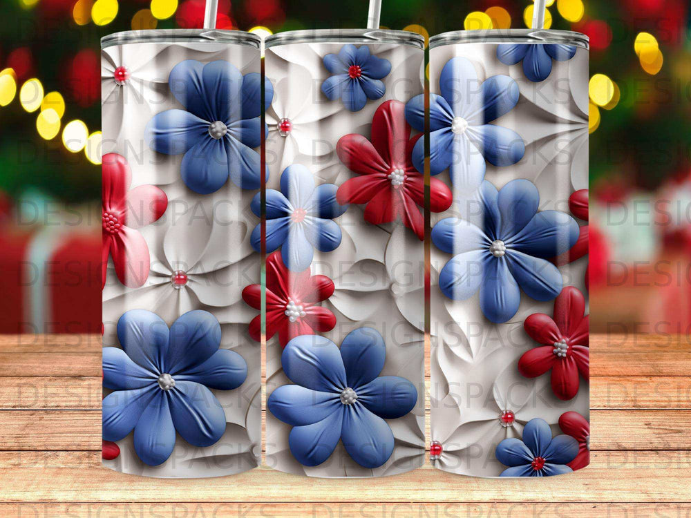 Three tumblers with red and blue floral designs on a wooden surface.