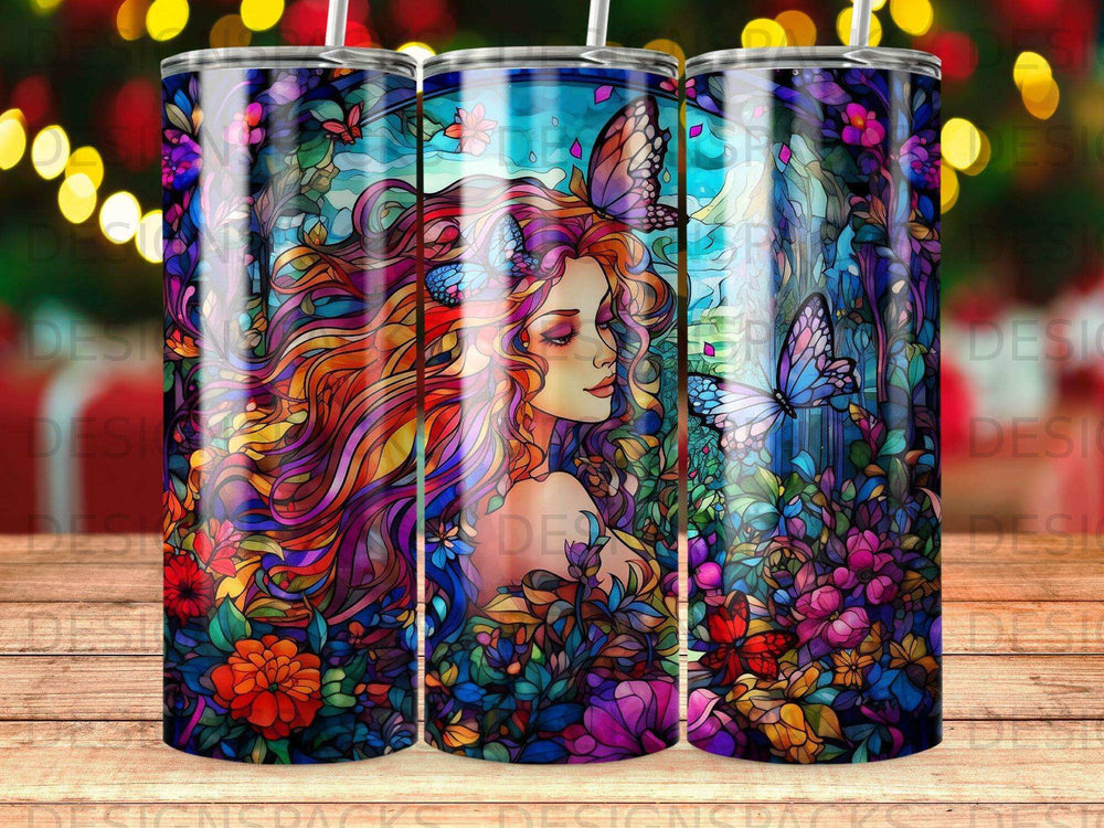 Artistic tumbler with woman and colorful floral and butterfly design.