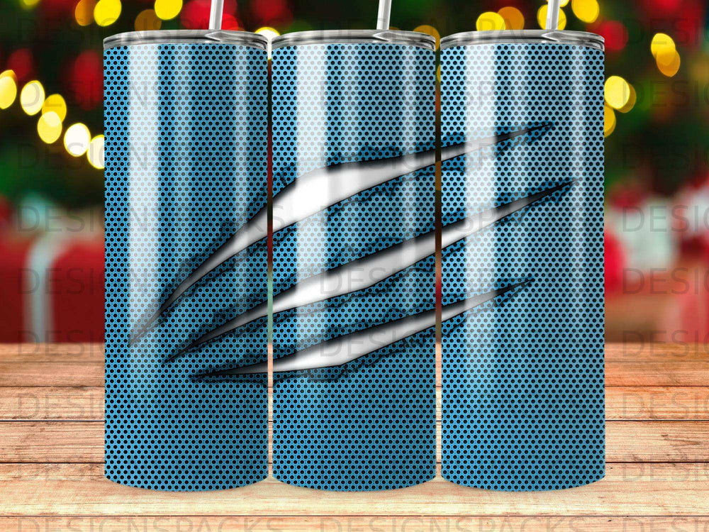 Blue textured tumbler with three silver claw marks and a bokeh background.