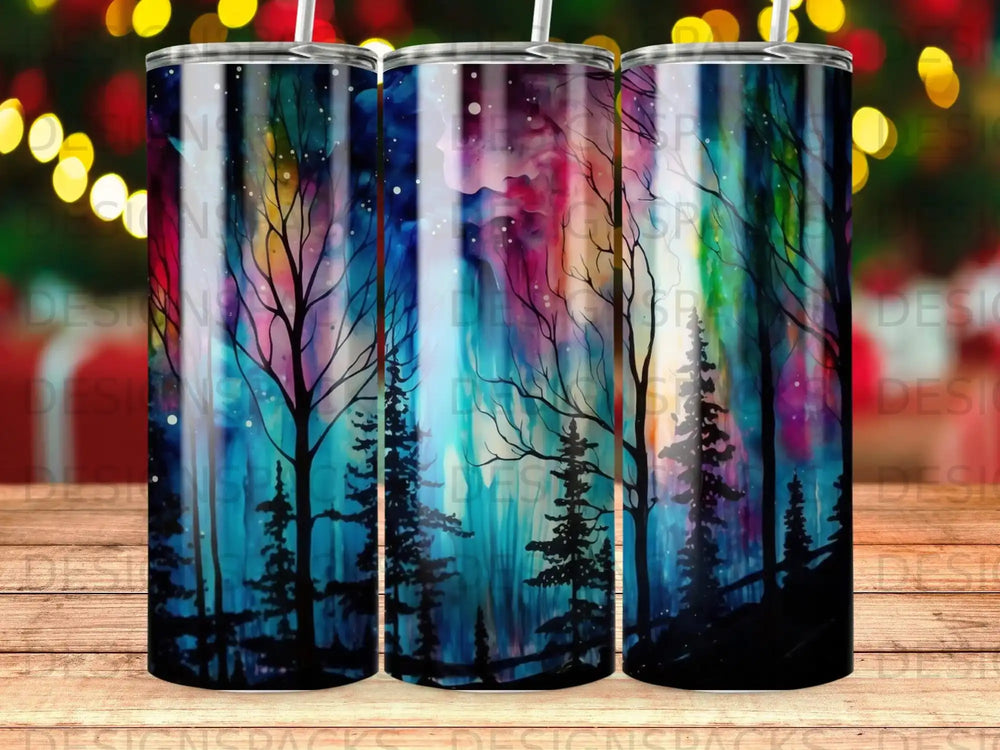Tumbler with a dark forest silhouette against a vibrant, abstract sky.