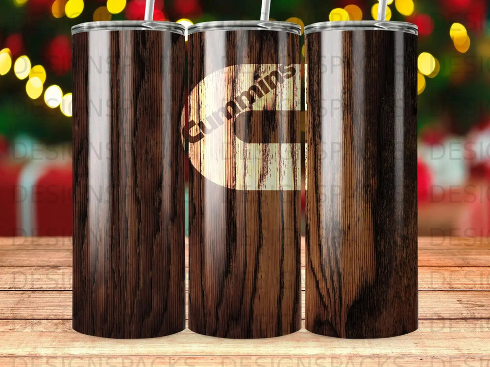 Three insulated tumblers with wood grain texture and the Cummins logo.