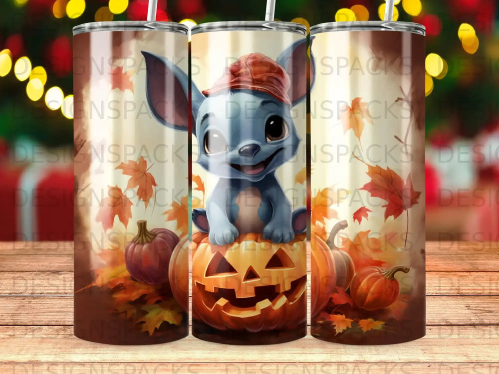 Cartoon blue creature with pumpkin hat sitting on carved pumpkin.