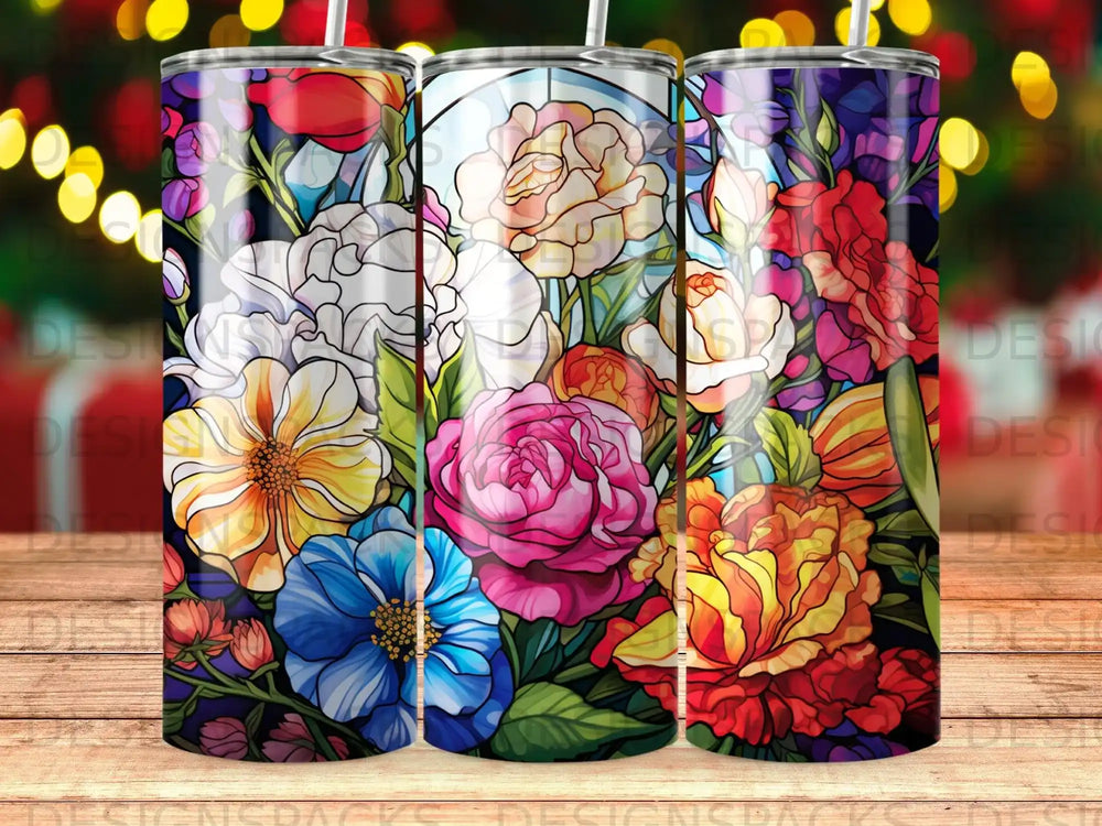 Stained glass floral design on three tumblers with bokeh background.