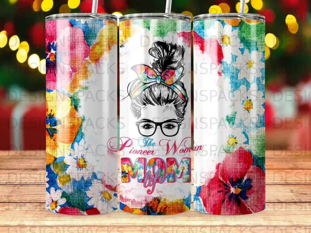 Floral tumbler with "Pioneer Mom" text and messy bun woman illustration.
