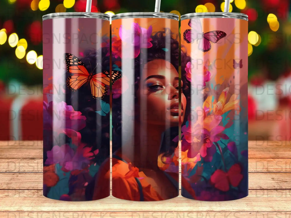 Tumbler with a woman's face, butterflies, and floral accents.
