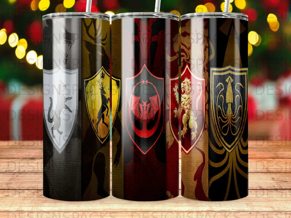Four tumblers with fantasy-themed crests and symbols on a wooden surface.