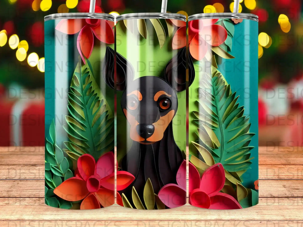 Black and tan dog peeking through tropical leaves and flowers on a tumbler.