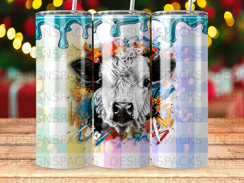 Black and white cow face with colorful abstract paint splashes.