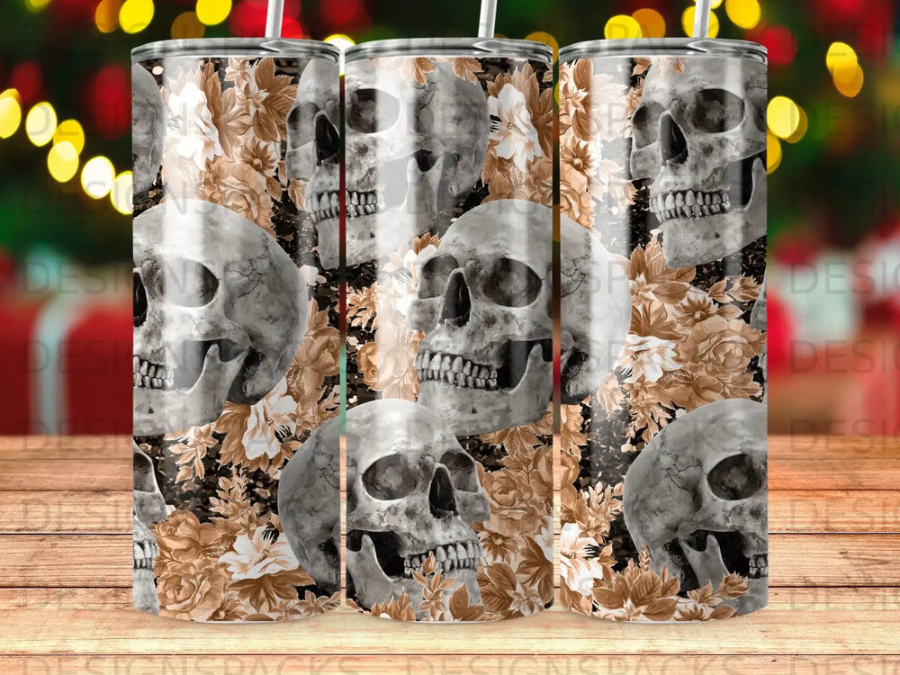 Skulls and floral pattern on a tumbler with bokeh lights in the background.