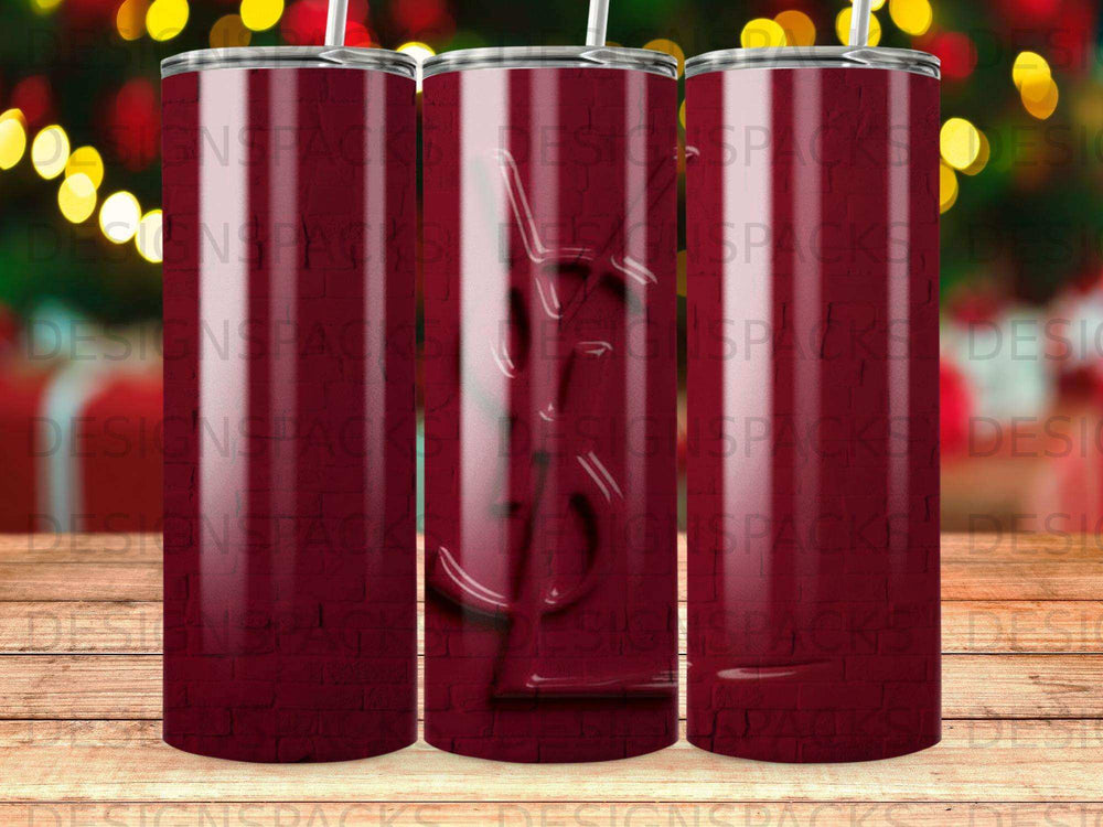 Burgundy tumbler with repeating gold YSL logo pattern.