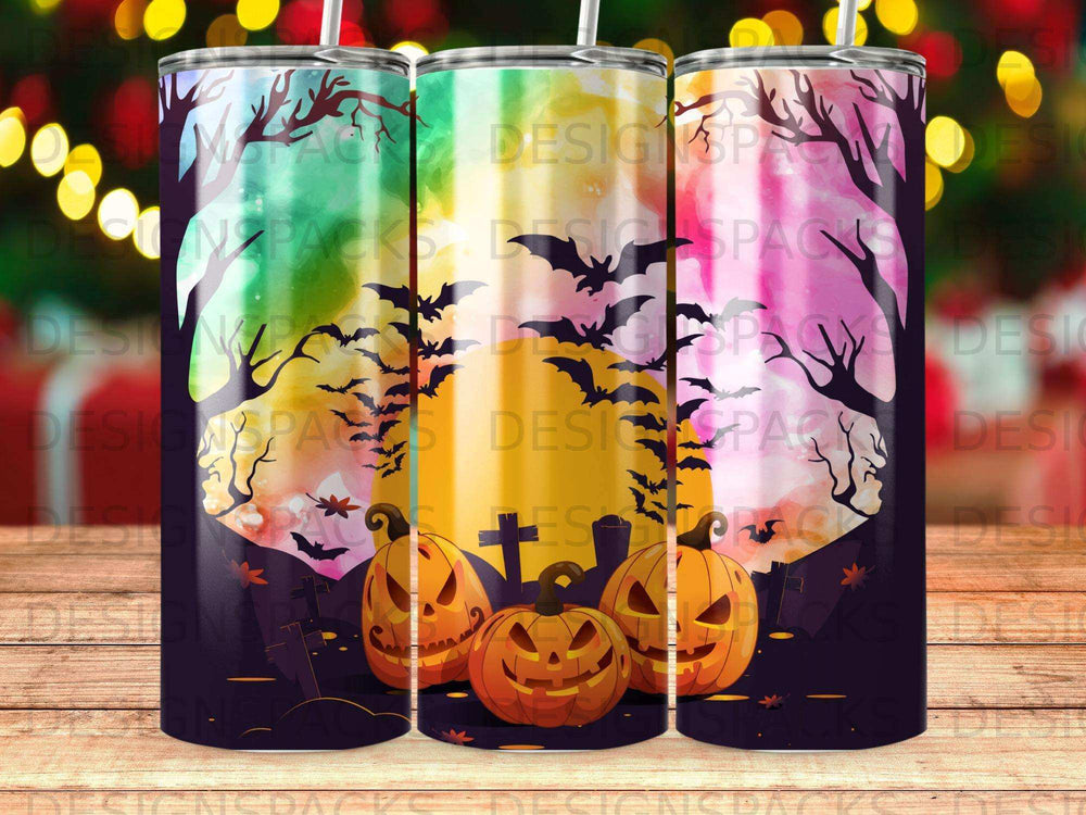 Halloween tumbler featuring three jack-o'-lanterns, bats, and tombstones against a dark sky.