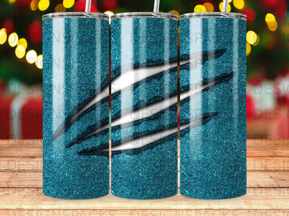 Glitter tumbler with claw marks and iridescent blue and teal streaks.