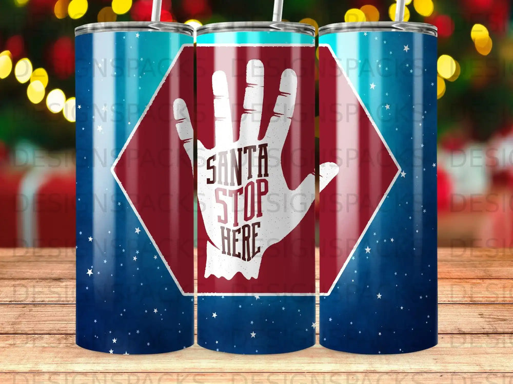 Tumbler with Santa stop here hand symbol on a starry blue background.