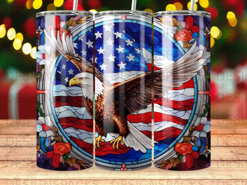 Bald eagle with American flag and floral border design on a tumbler.