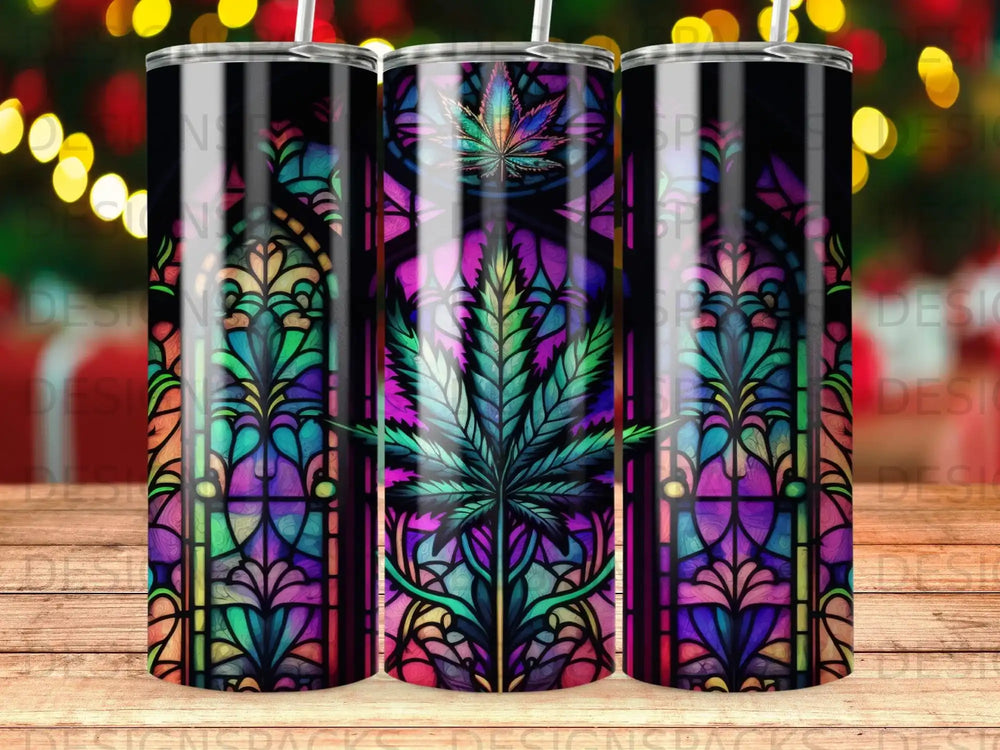 Stained glass tumbler with cannabis leaf design and festive lights.