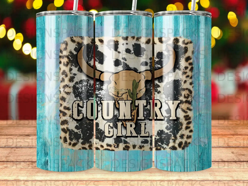 Tumbler with cow print, cactus, and "Country Girl" text on wood background.