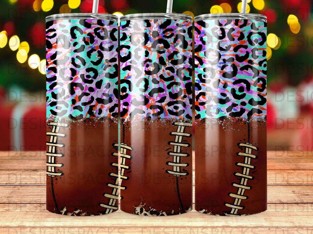 Leopard print and football pattern tumbler with straws and bokeh background.