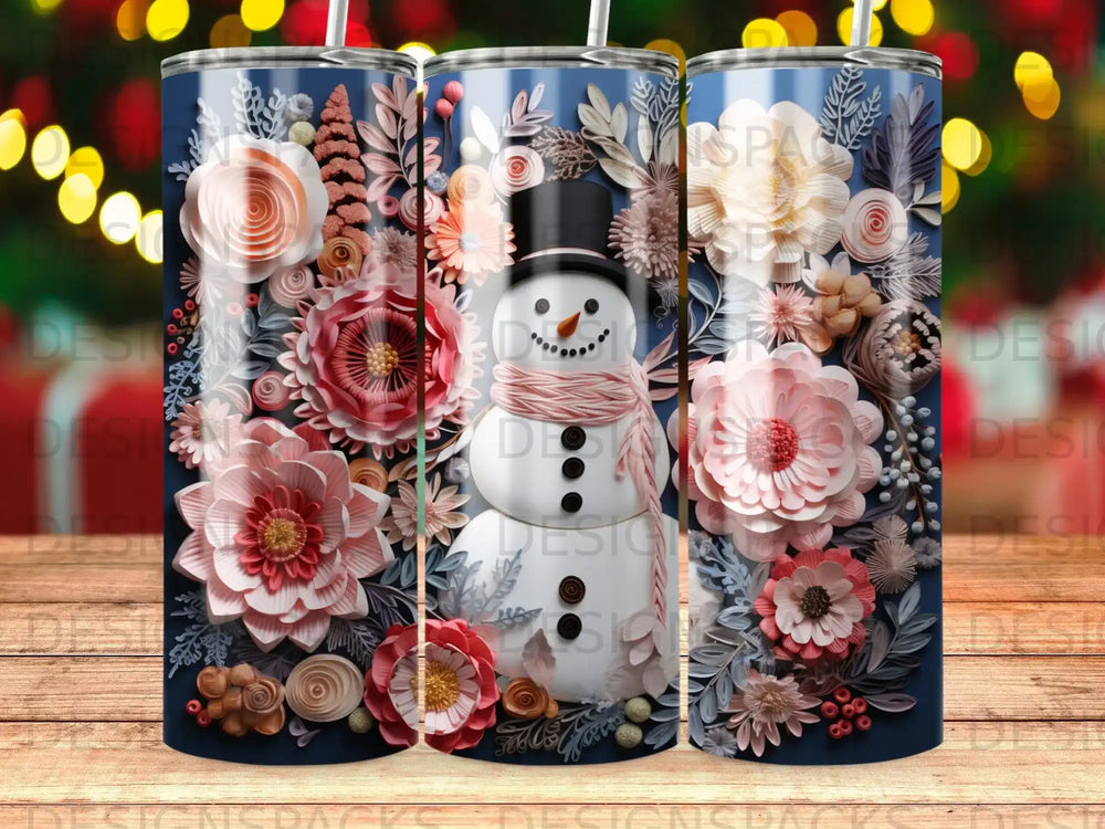 Snowman wearing a pink scarf surrounded by elaborate floral designs on a navy blue tumbler.