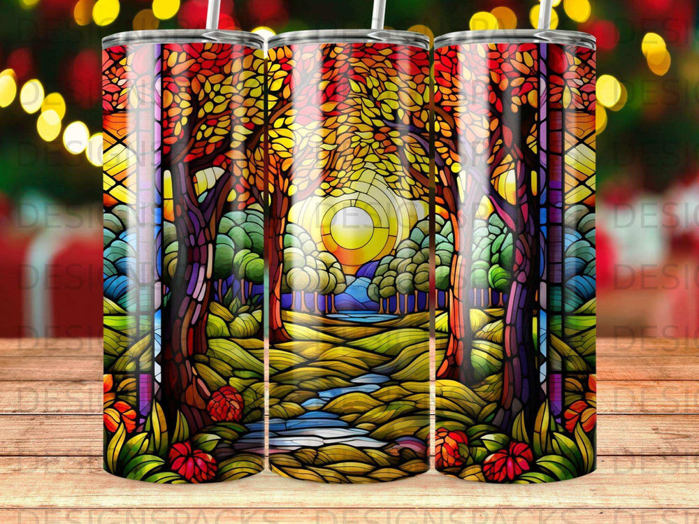 Stained glass forest scene with sun, river, and vibrant autumn trees.