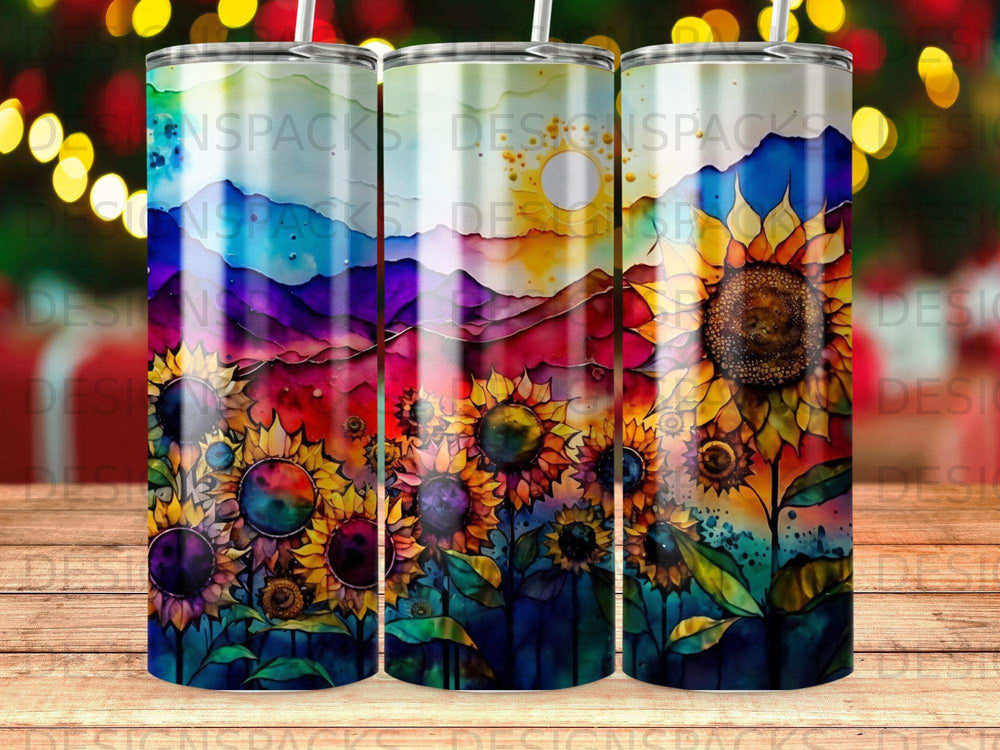 Three tumblers featuring watercolor sunflowers and a mountain sunset.