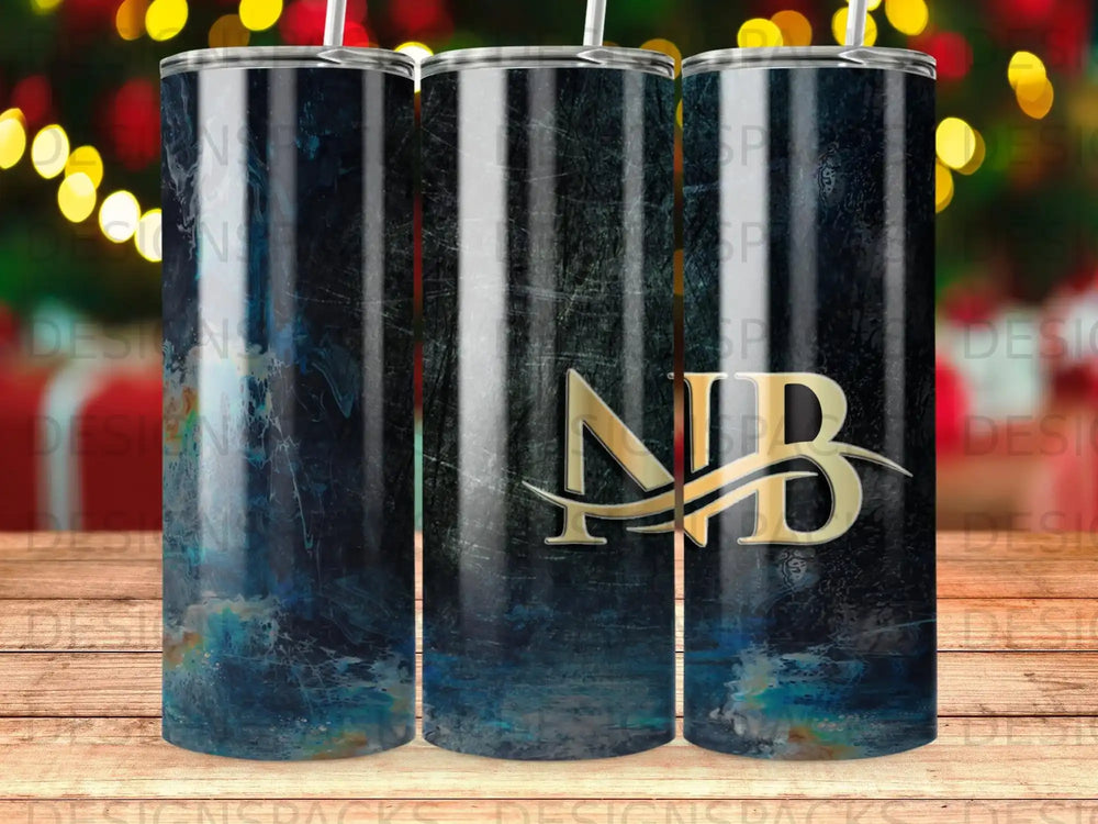 Gold NB logo on a dark, abstract textured tumbler with blurred Christmas lights.