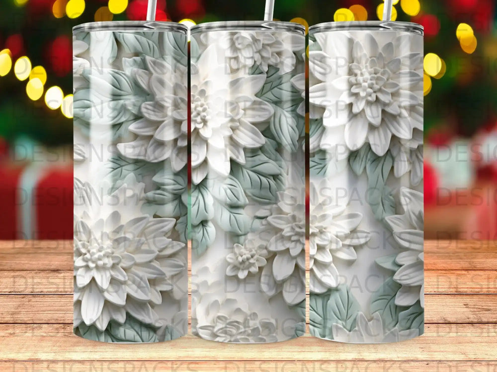 Three white floral tumblers with embossed petals and green leaves on a wooden surface.