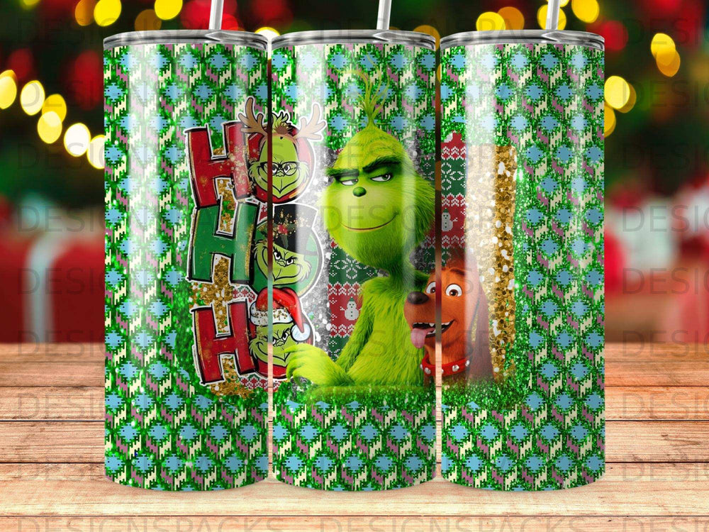 The Grinch and Max wear Santa hats on a green, red, and blue holiday tumbler.